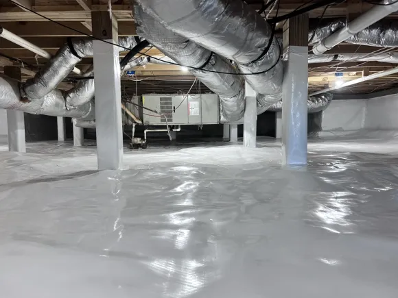 Sealed crawlspace with wrapped support piers, insulated joists, and clean ductwork